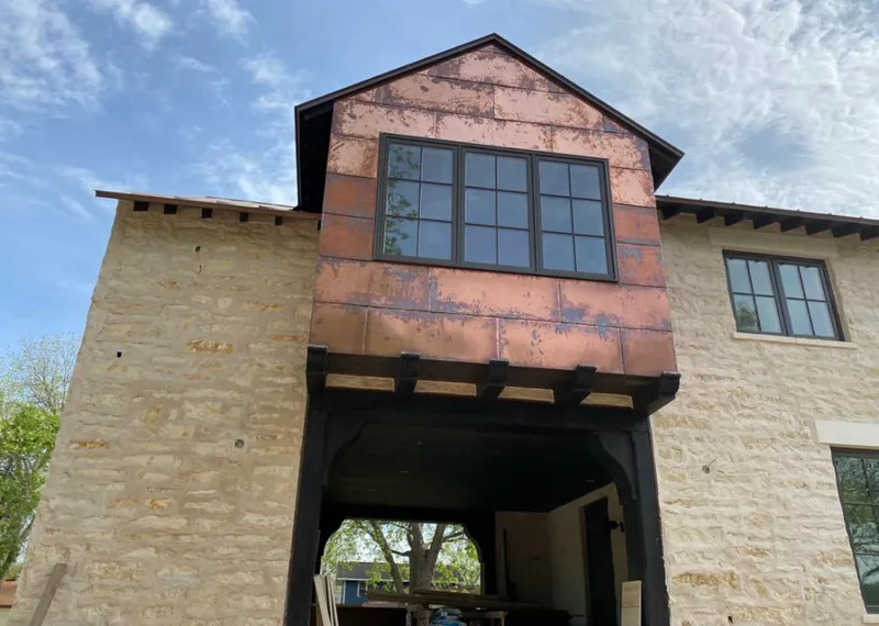 Copper metal panel facade on a stone building for Skylight Installation in Cedar Hills
