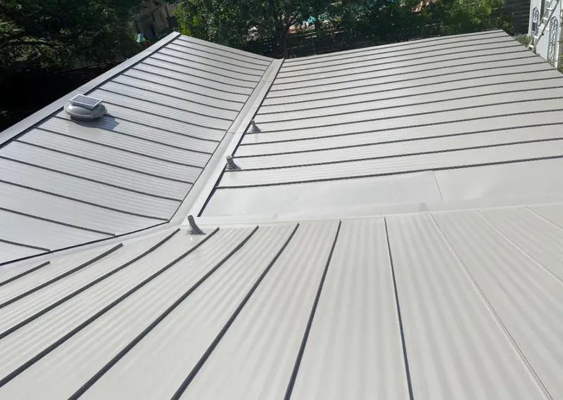 Solar attic fan installed on a metal roof for Roof Ventilation in Cedar Hills